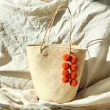 Borneo Serena Straw Tote Bag With Pumpkin Orange Pom-Poms - ourCommonplace